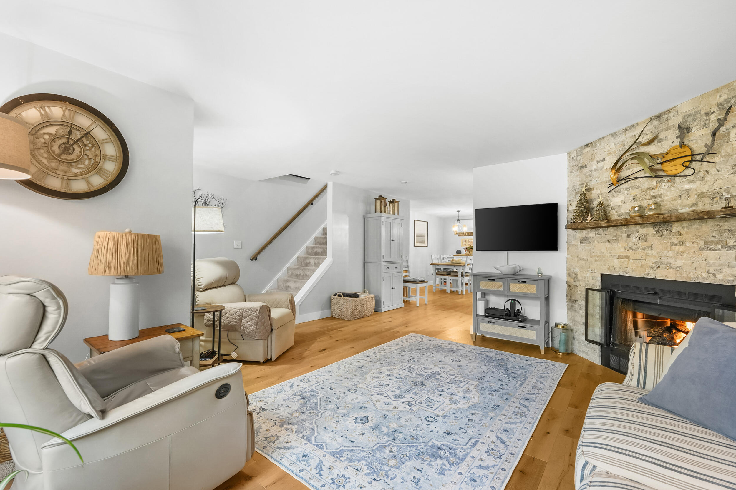 195 Falmouth Road, Unit 7B Mashpee, MA 02649 - Photo 6 of 38 a living room with furniture a flat screen tv and a fireplace