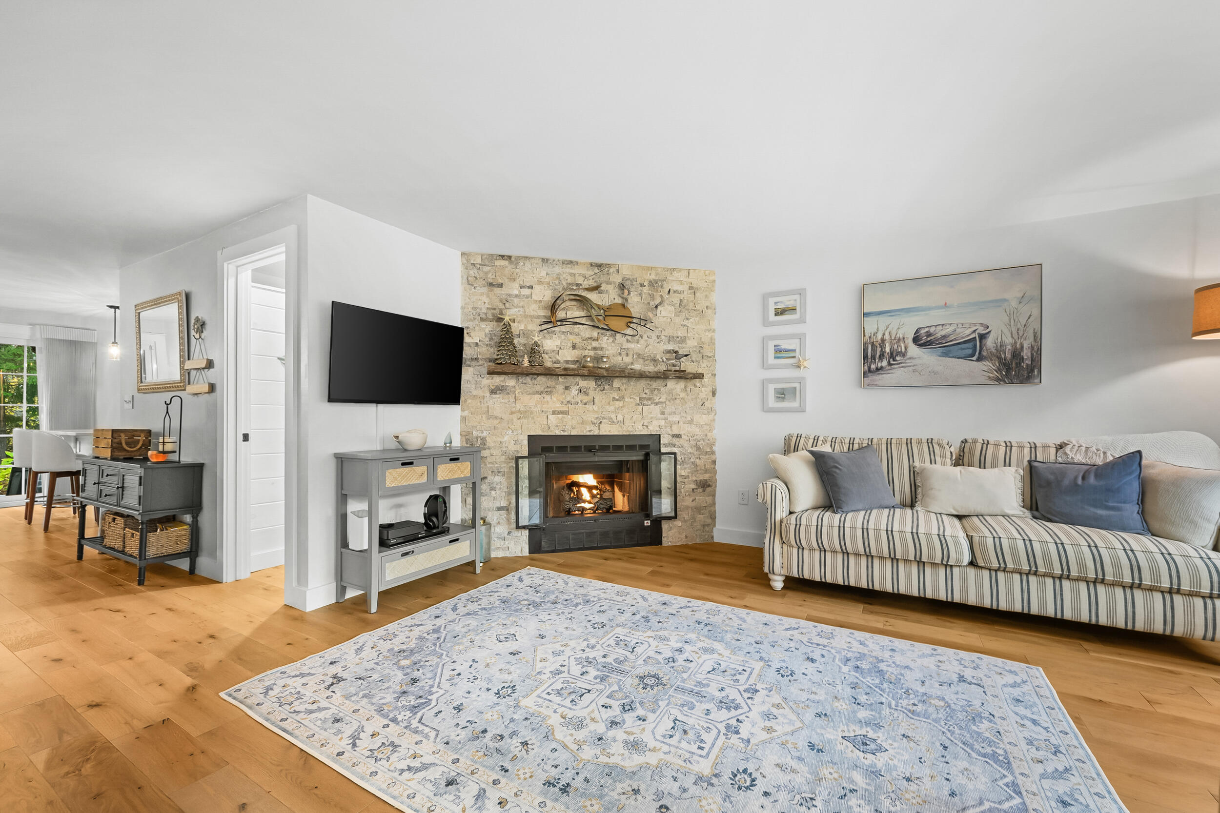 195 Falmouth Road, Unit 7B Mashpee, MA 02649 - Photo 7 of 38 a living room with furniture and a fireplace