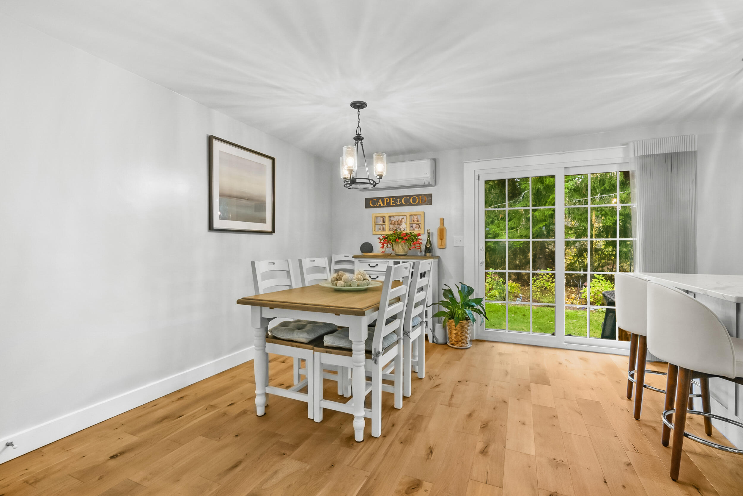 195 Falmouth Road, Unit 7B Mashpee, MA 02649 - Photo 9 of 38 a dining room with furniture a rug and wooden floor