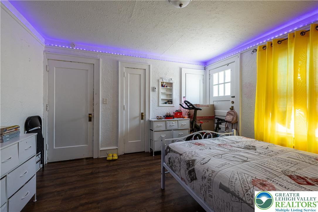 118 South 3rd Street Bangor, PA 18013 - Photo 15 of 33 This cozy bedroom features durable flooring and a bright window, offering a comfortable personal retreat.