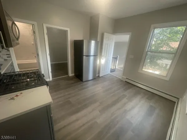 a view of a kitchen with wooden floor and a sink