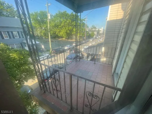 a view of balcony with floor to ceiling windows and wooden fence