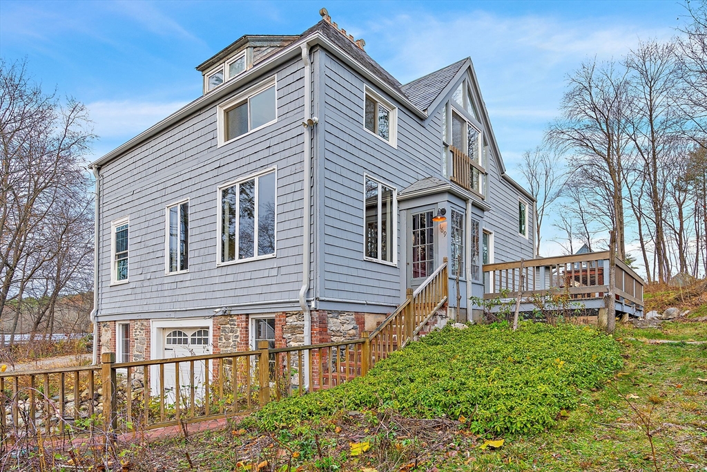a view of a house with a yard and potted plants