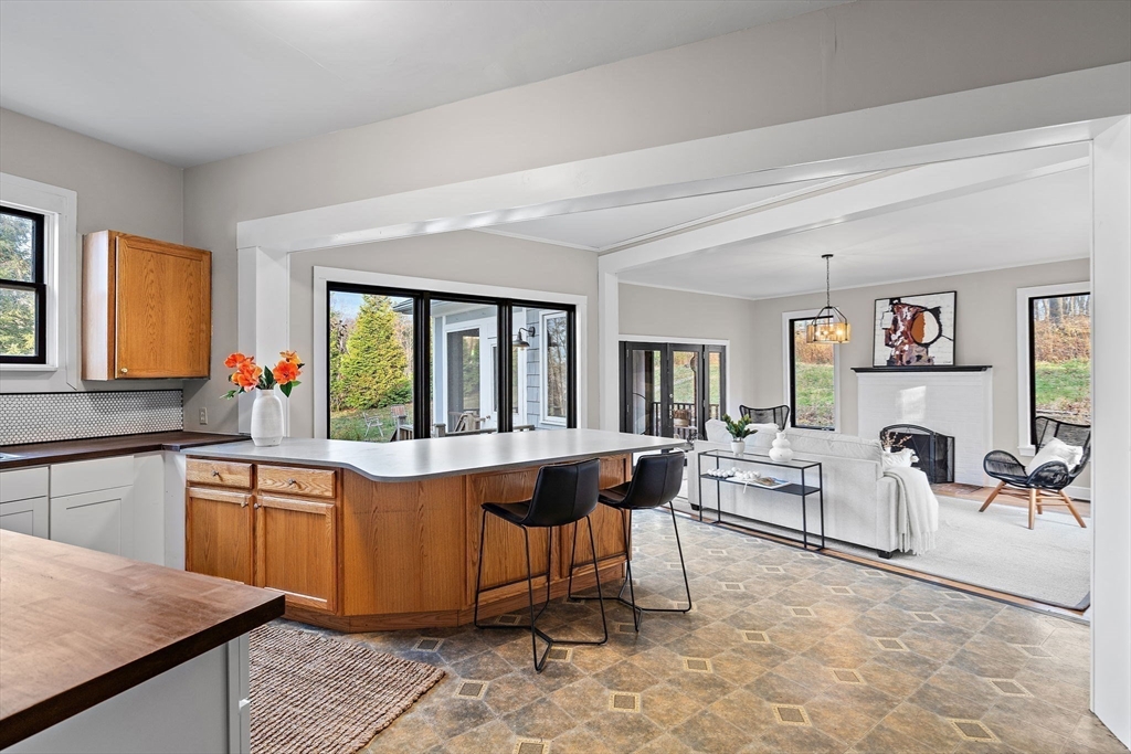 169 Main Street Acton, MA 01720 - Photo 12 of 39 a living room with fireplace furniture and a large window