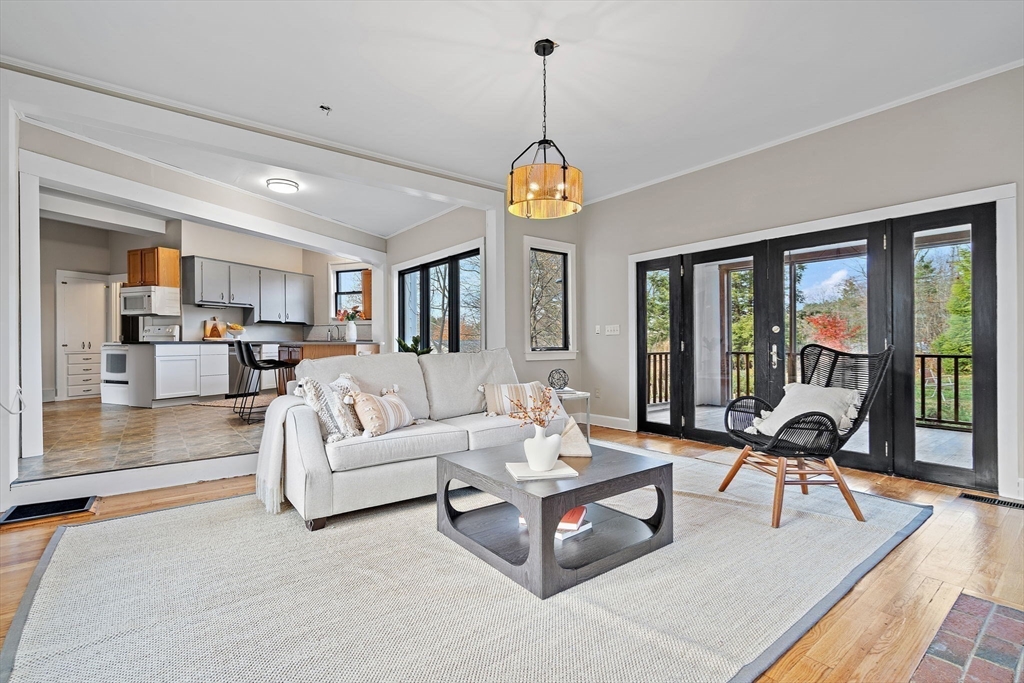 169 Main Street Acton, MA 01720 - Photo 15 of 39 a living room with furniture a floor to ceiling window and wooden floor