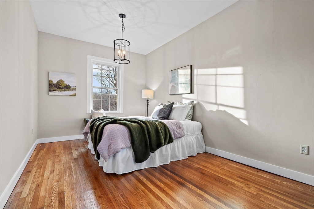 169 Main Street Acton, MA 01720 - Photo 18 of 39 a bedroom with a bed and wooden floor