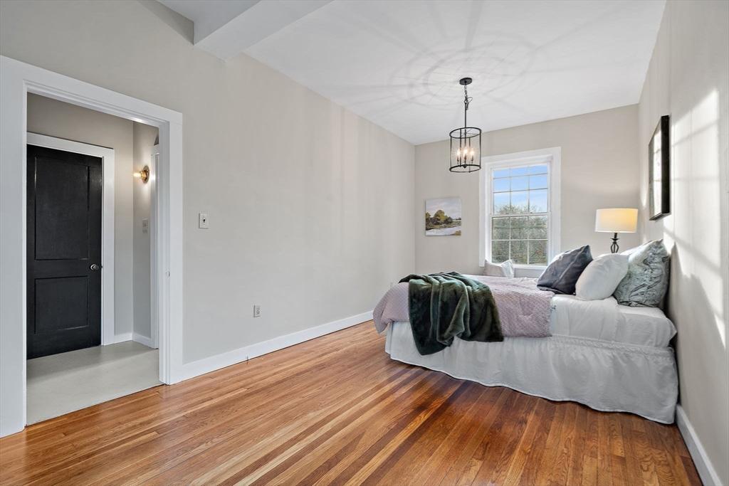 169 Main Street Acton, MA 01720 - Photo 20 of 39 a bedroom with a bed and wooden floor