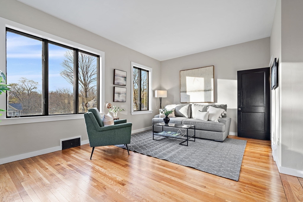 169 Main Street Acton, MA 01720 - Photo 2 of 39 a living room with furniture and a large window