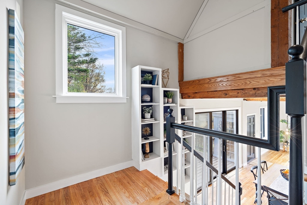 169 Main Street Acton, MA 01720 - Photo 22 of 39 a view of a hallway with wooden floor and staircase