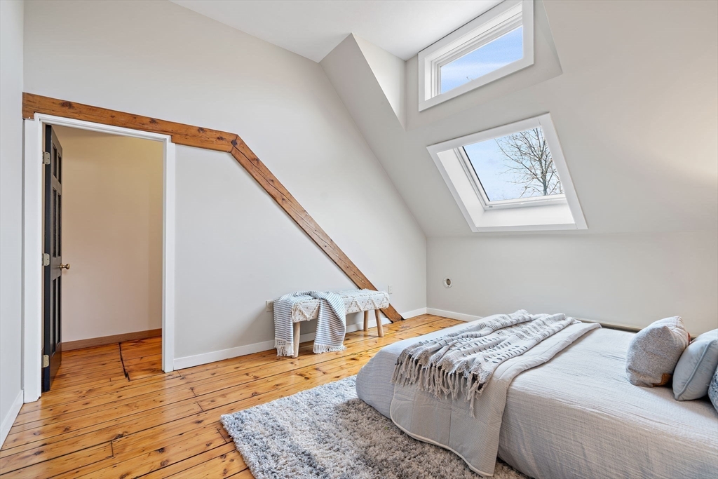 169 Main Street Acton, MA 01720 - Photo 25 of 39 a bedroom with a bed and wooden floor