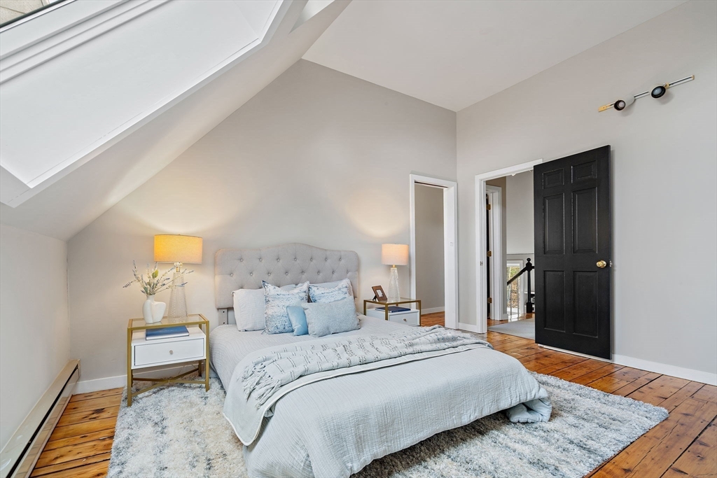 169 Main Street Acton, MA 01720 - Photo 27 of 39 a bedroom with a bed and wooden floor