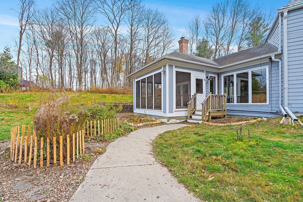 169 Main Street Acton, MA 01720 - Photo 31 of 39 a front view of a house with swimming pool garden and outdoor seating