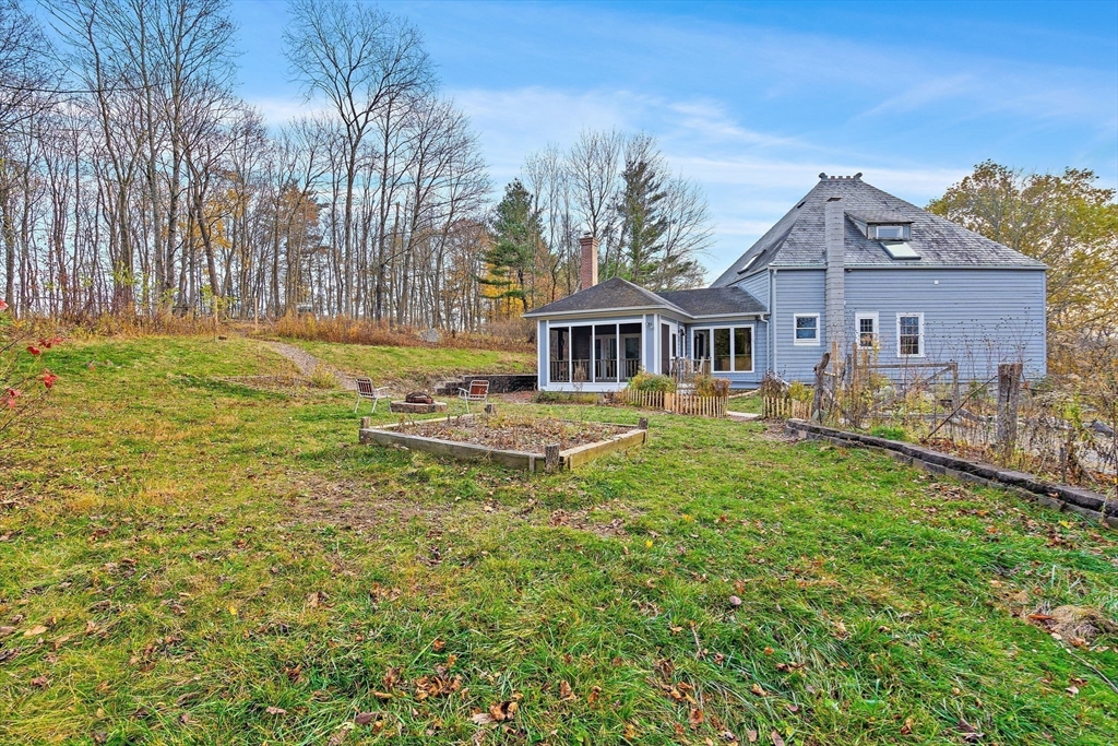 169 Main Street Acton, MA 01720 - Photo 32 of 39 a view of a house with a big yard and potted plants