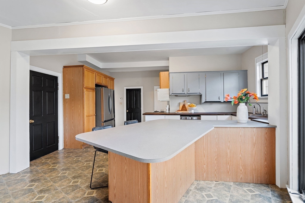169 Main Street Acton, MA 01720 - Photo 9 of 39 a kitchen with stainless steel appliances a stove refrigerator sink and cabinets