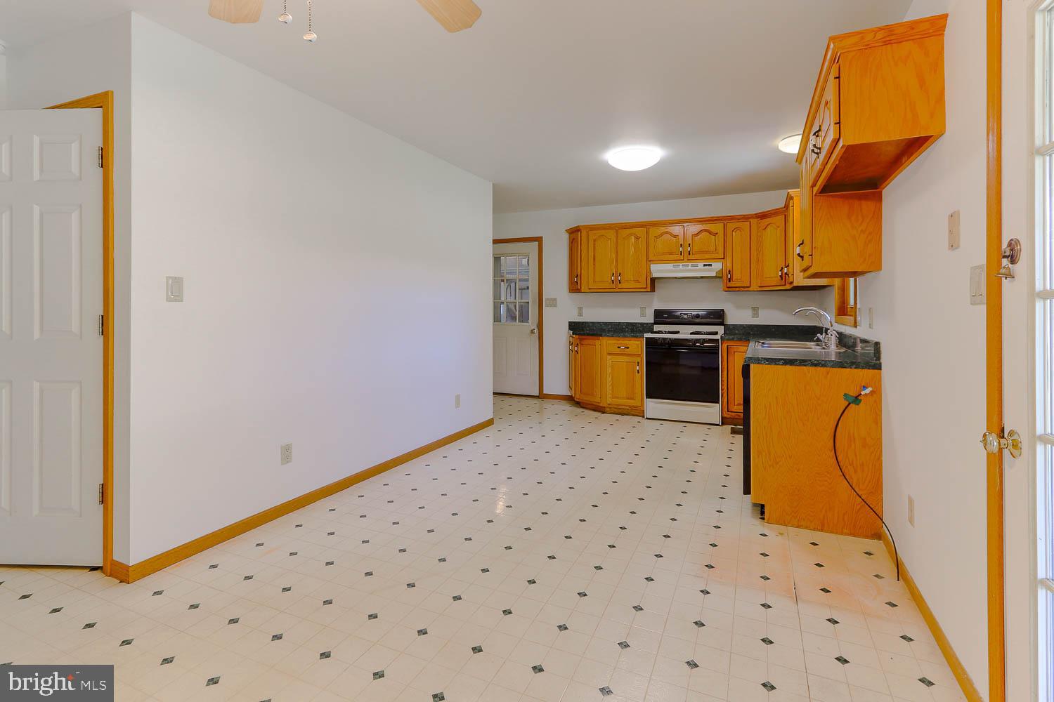 10 Flat Land Road Lewistown, PA 17044 - Photo 17 of 64 a kitchen with a sink a stove top oven a chimney and a refrigerator