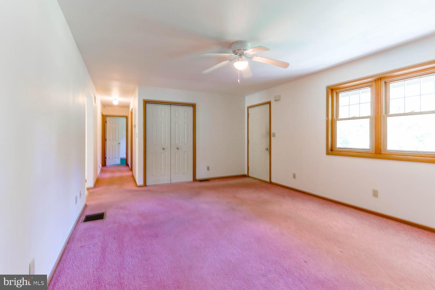 10 Flat Land Road Lewistown, PA 17044 - Photo 27 of 64 an empty room with chandelier fan and windows