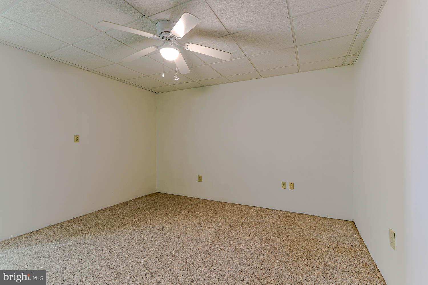 10 Flat Land Road Lewistown, PA 17044 - Photo 37 of 64 an empty room with a chandelier fan and windows