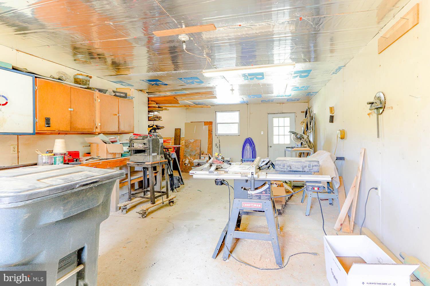 10 Flat Land Road Lewistown, PA 17044 - Photo 57 of 64 a room with lots of white furniture a chandelier and a dining table