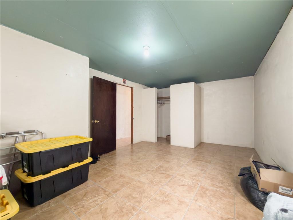 21707 Hidalgo Street Edcouch, TX 78538 - Photo 16 of 27 a bedroom with a bed and cabinets