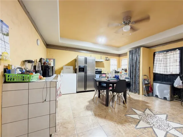 a kitchen with refrigerator and window