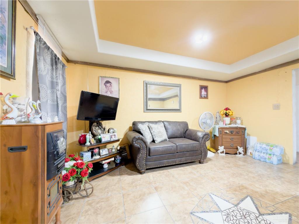 21707 Hidalgo Street Edcouch, TX 78538 - Photo 22 of 27 a living room with furniture and a flat screen tv