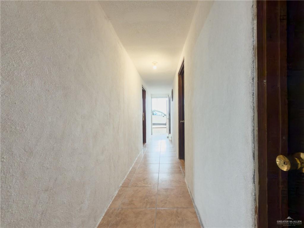 21707 Hidalgo Street Edcouch, TX 78538 - Photo 23 of 27 a view of a hallway with wooden floor