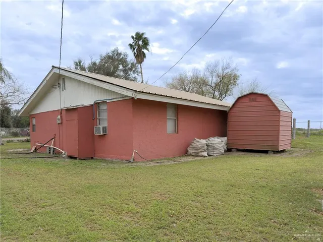 a backyard of a house with table and chairs