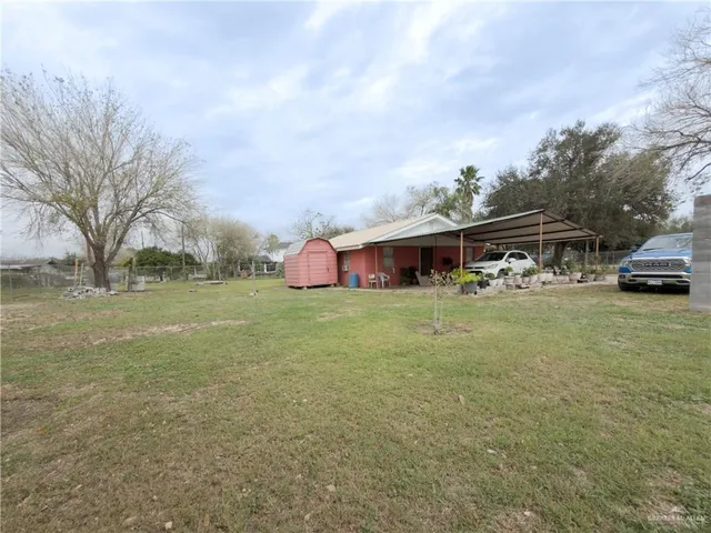 a front view of house with yard and trees