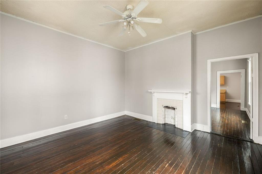 796 Fulton Terrace Southeast Atlanta, GA 30316 - Photo 14 of 35 an empty room with wooden floor fan and windows