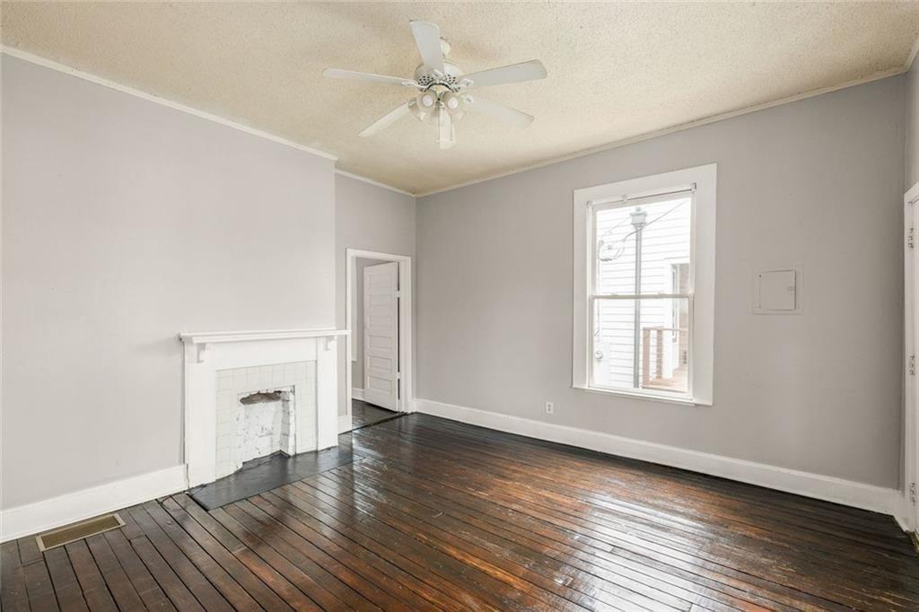 796 Fulton Terrace Southeast Atlanta, GA 30316 - Photo 15 of 35 an empty room with wooden floor a ceiling fan and windows
