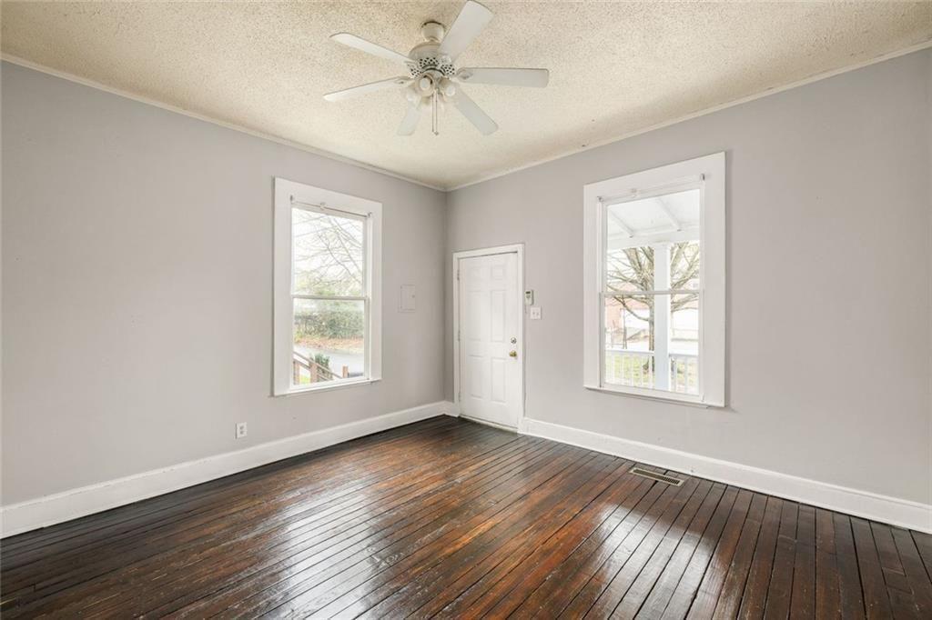 796 Fulton Terrace Southeast Atlanta, GA 30316 - Photo 16 of 35 a view of an empty room with a window and wooden floor