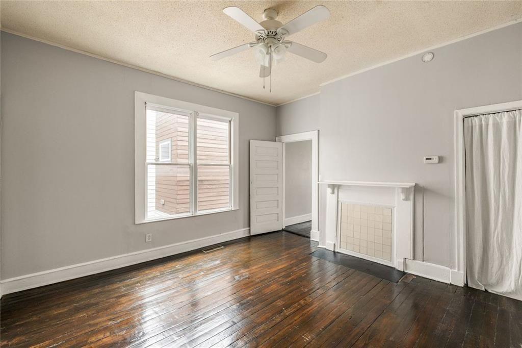 796 Fulton Terrace Southeast Atlanta, GA 30316 - Photo 18 of 35 a view of an empty room with wooden floor and a window