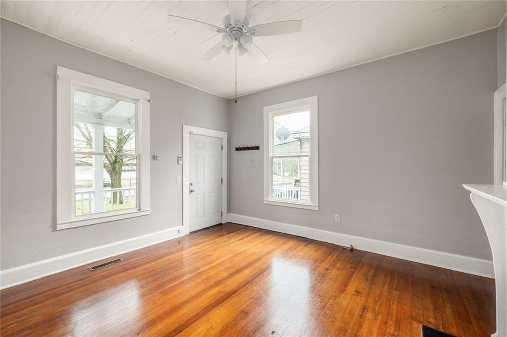 796 Fulton Terrace Southeast Atlanta, GA 30316 - Photo 5 of 35 a view of an empty room with a window and wooden floor