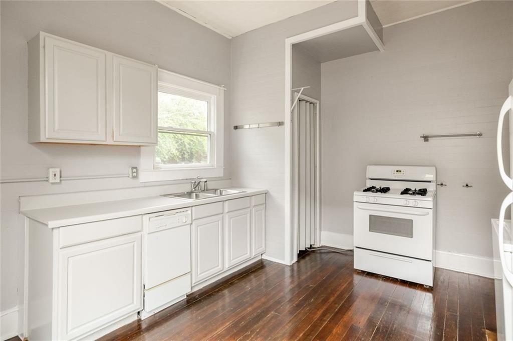796 Fulton Terrace Southeast Atlanta, GA 30316 - Photo 9 of 35 a kitchen with white cabinets and white appliances