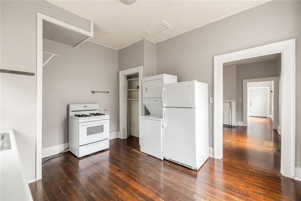 796 Fulton Terrace Southeast Atlanta, GA 30316 - Photo 10 of 35 a kitchen with a refrigerator a stove and wooden floor