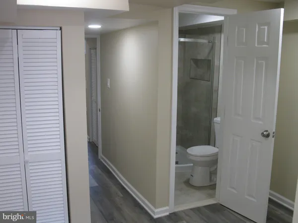 a bathroom with a toilet and a shower