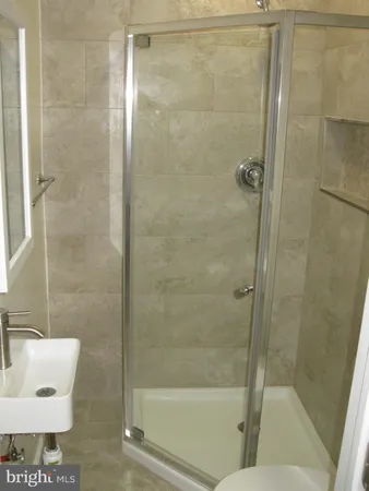 a view of a small space with wooden floor closet and windows