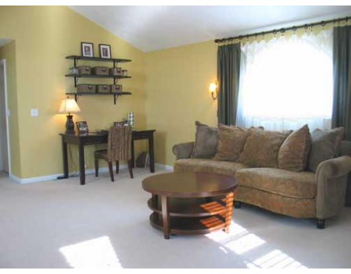 389 Mulpus Road Lunenburg, MA 01462 - Photo 14 of 26 a living room with couches a coffee table and a chandelier with kitchen view