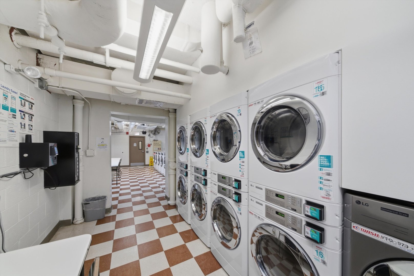 6301 North Sheridan Road, Unit 14G Chicago, IL 60660 - Photo 14 of 22 a hallway with a washer and dryer