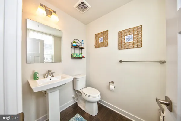 a bathroom with a toilet a sink and mirror