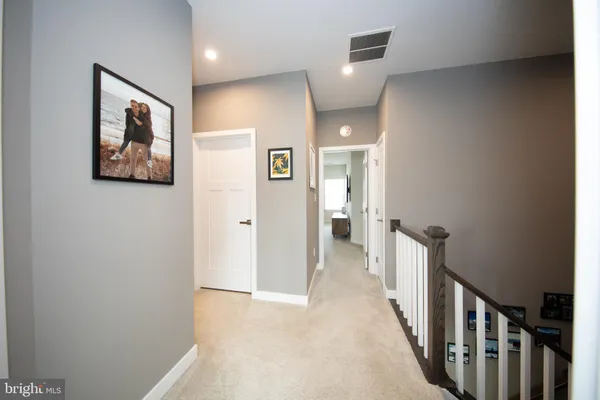 a view of a hallway with paintings on the wall