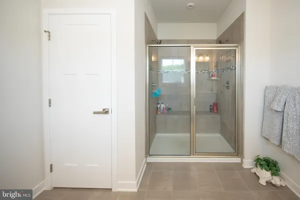 a bathroom with a glass shower door
