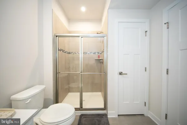 a bathroom with a toilet and a shower