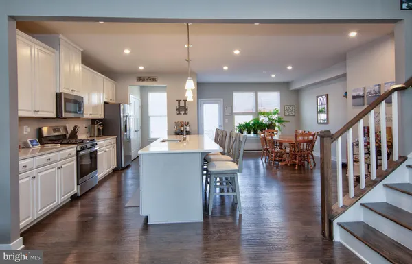 a large open kitchen with a large window and stainless steel appliances