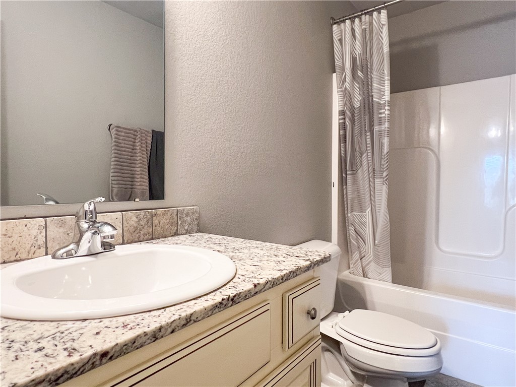 1275 North Rupple Road Fayetteville, AR 72704 - Photo 12 of 20 Bathroom featuring a vanity with an integrated sink, polished chrome faucet, and a granite-style countertop