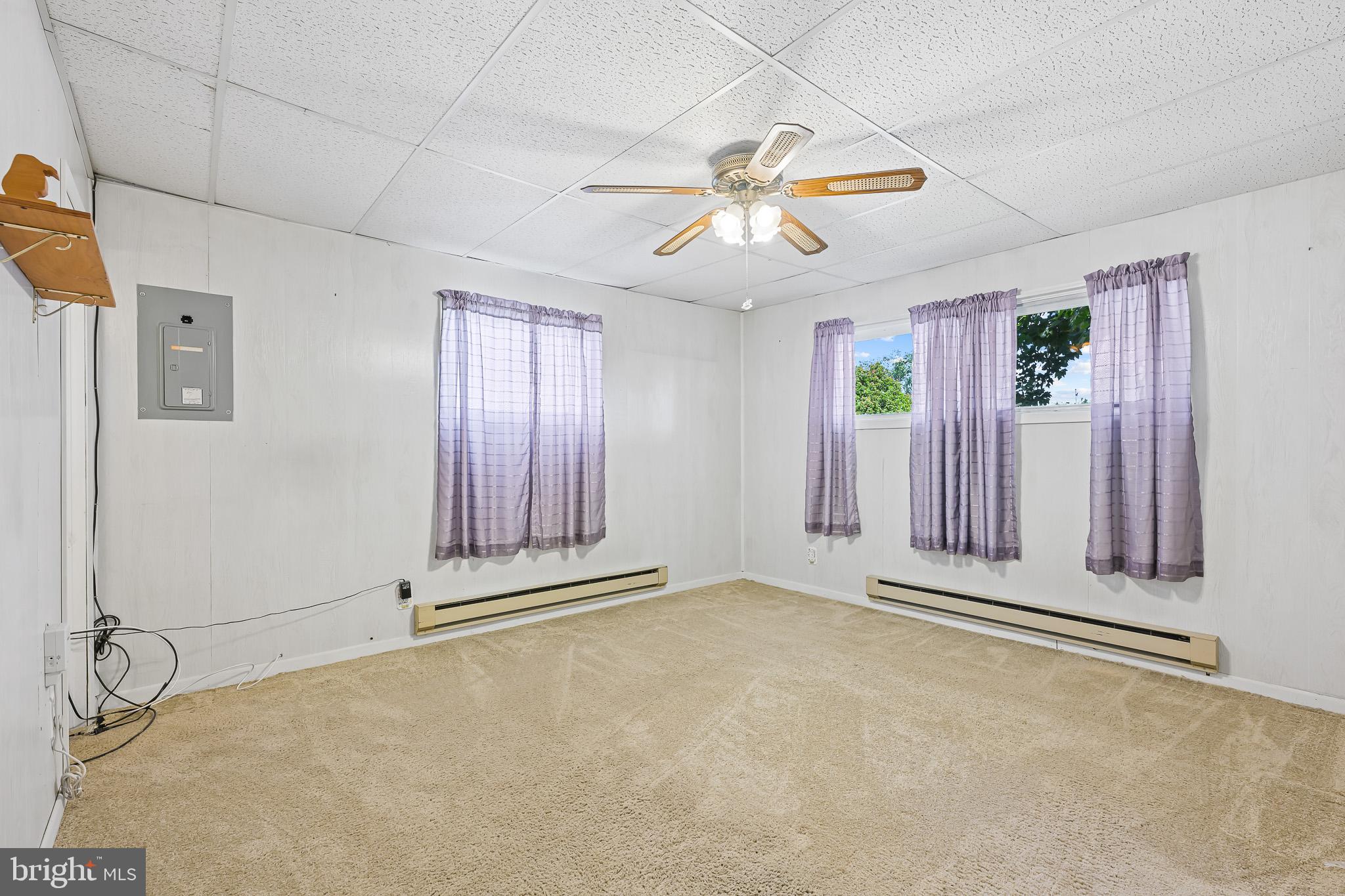 8 Augusta Drive Newark, DE 19713 - Photo 14 of 23 an empty room with windows and fan chandelier