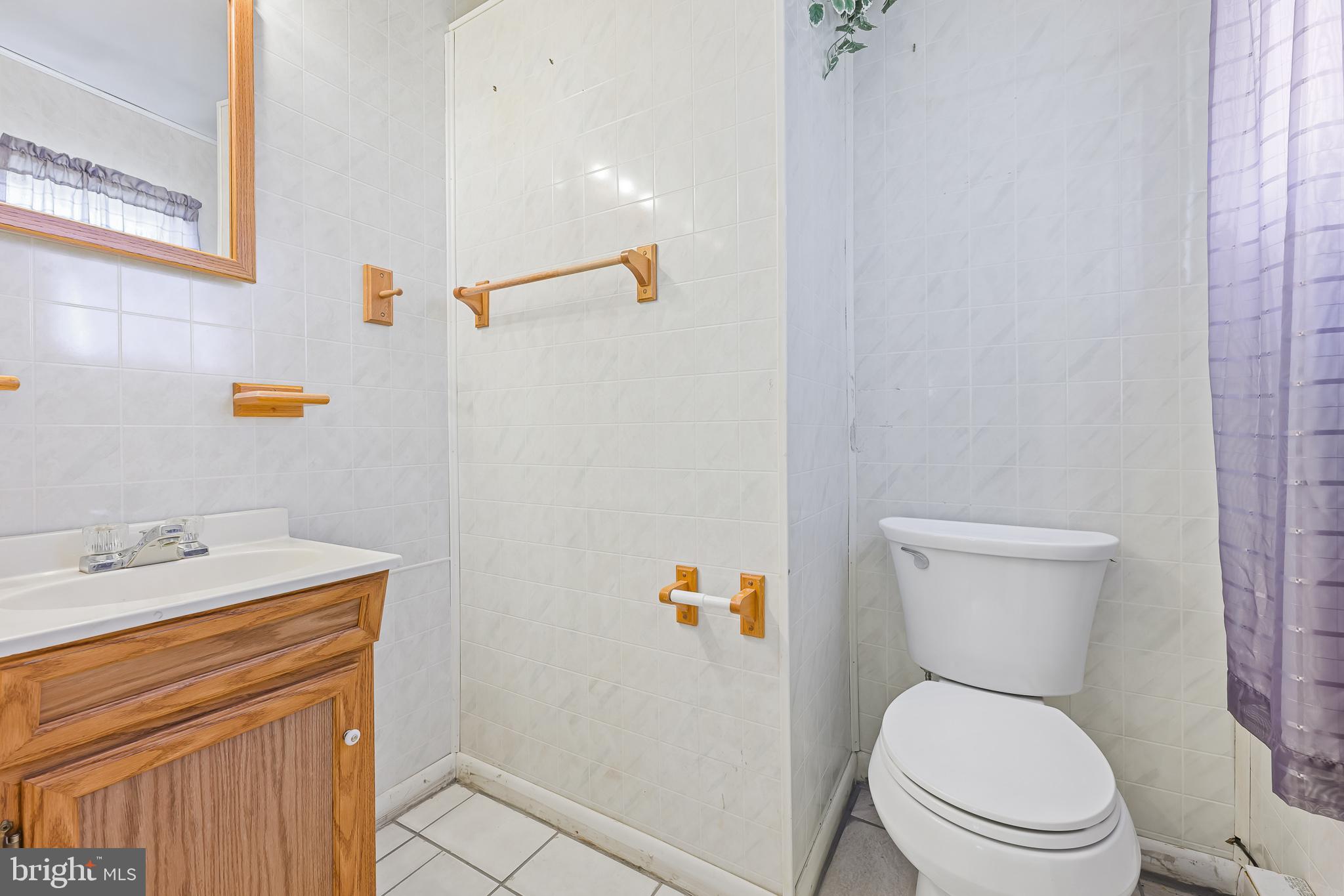 8 Augusta Drive Newark, DE 19713 - Photo 16 of 23 a white toilet sitting next to a bathroom sink