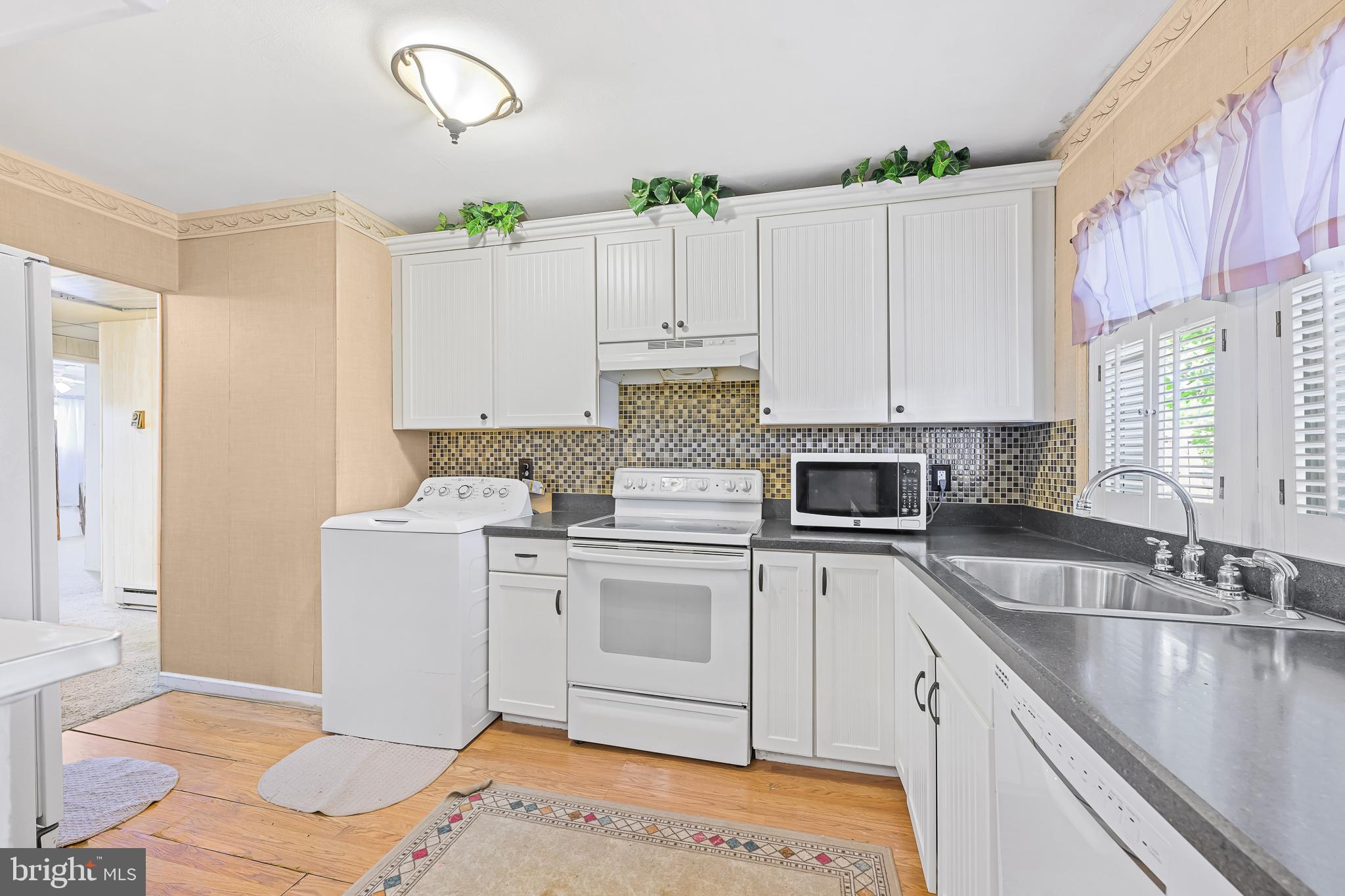 8 Augusta Drive Newark, DE 19713 - Photo 8 of 23 a kitchen with a sink stove and cabinets