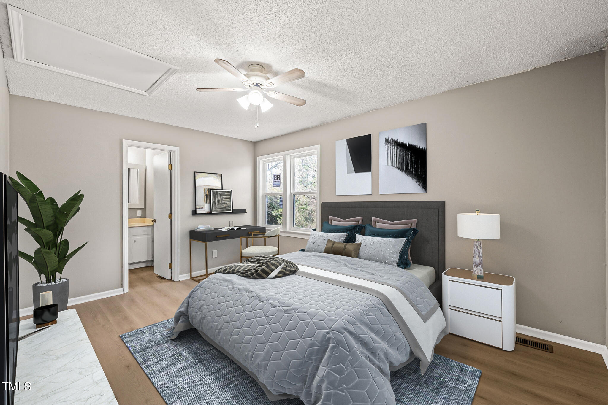 621 Bashford Road Raleigh, NC 27606 - Photo 8 of 29 a bedroom with a large bed and a chandelier