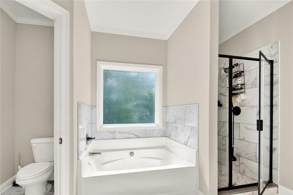 407 Corinth Church Road Winder, GA 30680 - Photo 43 of 66 a bathroom with a bathtub and a shower
